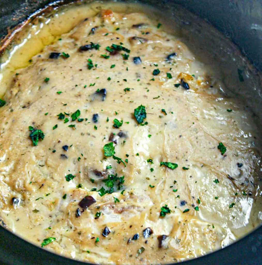 A creamy mushroom sauce with herbs in a pot, perfect for elevating your dinner recipes.
