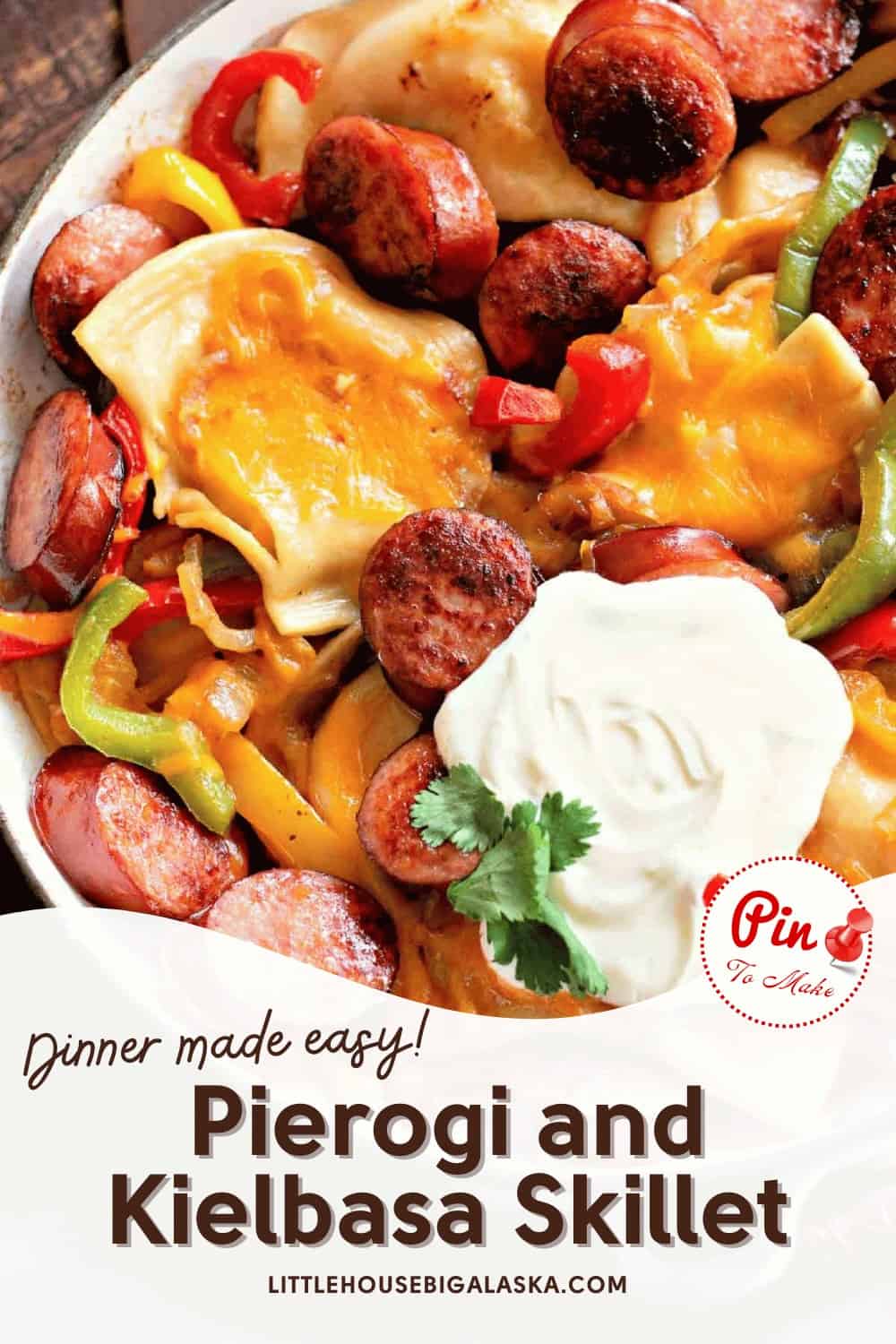 A skillet with pierogi, kielbasa, bell peppers, and melted cheese, topped with sour cream and cilantro. Text overlay reads "Dinner made easy! Pierogi and Kielbasa Skillet.