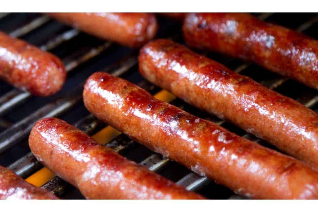 Close-up of sausages grilling on a barbecue.