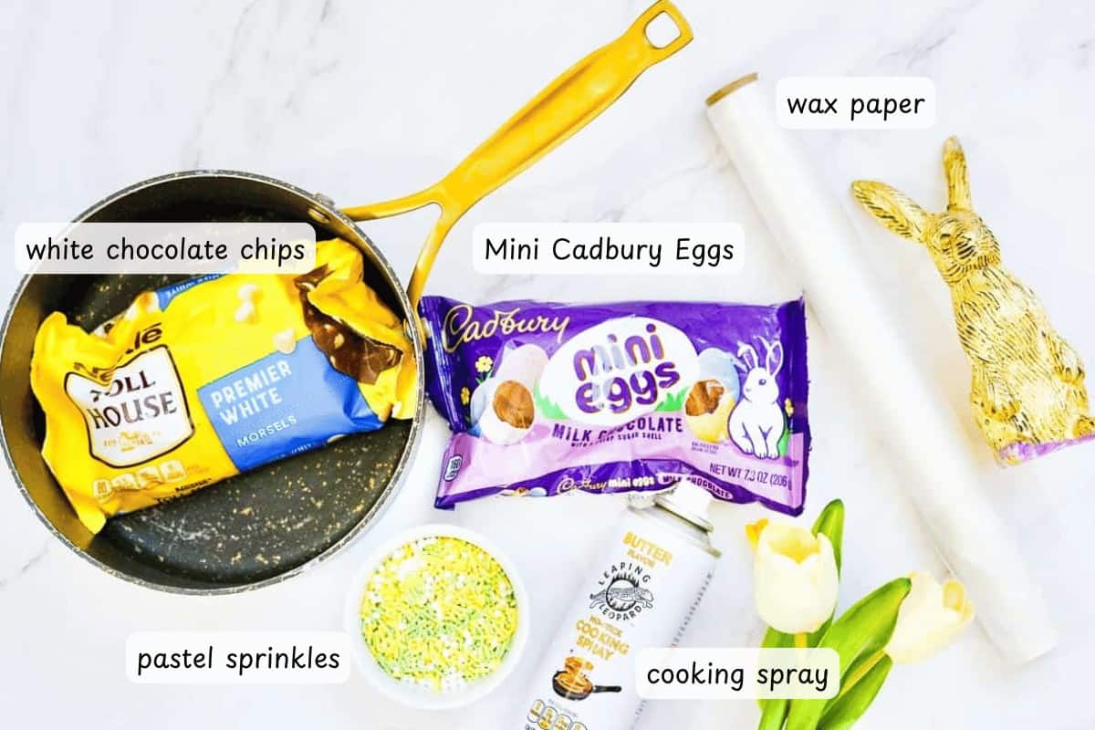 Create a delightful Easter Candy Bark with white chocolate chips, Mini Cadbury Eggs, and pastel sprinkles. Use cooking spray on wax paper and garnish with a gold foil-wrapped rabbit on a marble surface for an extra touch of whimsy.