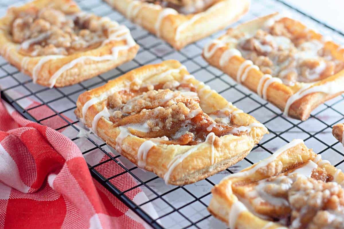 Icing on top of a apple crumble danish.