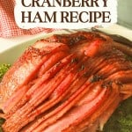 Sliced Baked Ham with Cranberry Pineapple Glaze on a white platter, garnished with parsley, with a "Cranberry Ham Recipe" text overlay.