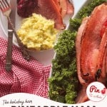 Plate with sliced ham, scrambled eggs, cranberry sauce, and a fork and knife on a red checkered napkin; nearby is a dish of Baked Ham with Cranberry Pineapple Glaze served on a bed of kale.