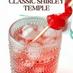 A glass of Shirley Temple with ice is garnished with two cherries on a stick. Text overlay reads "Classic Shirley Temple" and "Enjoy the cherry charm of this timeless Shirley Temple drink.