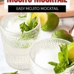 Two clear glasses filled with a refreshing mojito mocktail, garnished with fresh mint and lime slices, are placed on a white surface with extra lime and mint nearby.