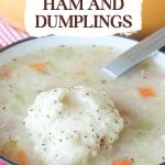 A bowl of Ham and Dumplings soup features diced carrots and celery, all topped with black pepper, with a spoon resting on the bowl's rim.