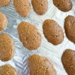 Several oval-shaped, brown cookies&mdash;reminiscent of crunchy peanut butter eggs&mdash;are arranged on a sheet of aluminum foil.