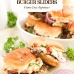 Three jalapeño popper sliders with melted cheese and toppings are arranged on a white plate and table, with parsley and onion garnish, showcasing a perfect party appetizer.