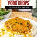 A maple Dijon pork chop sits atop mashed potatoes on a white plate, with green beans and a fork in the background. The text describes these maple dijon pork chops as sweet and tangy baked pork chops.