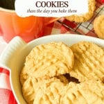 Peanut butter cookies in a white dish next to a mug of coffee, with text reading “Better on day two PEANUT BUTTER COOKIES than the day you bake them.”